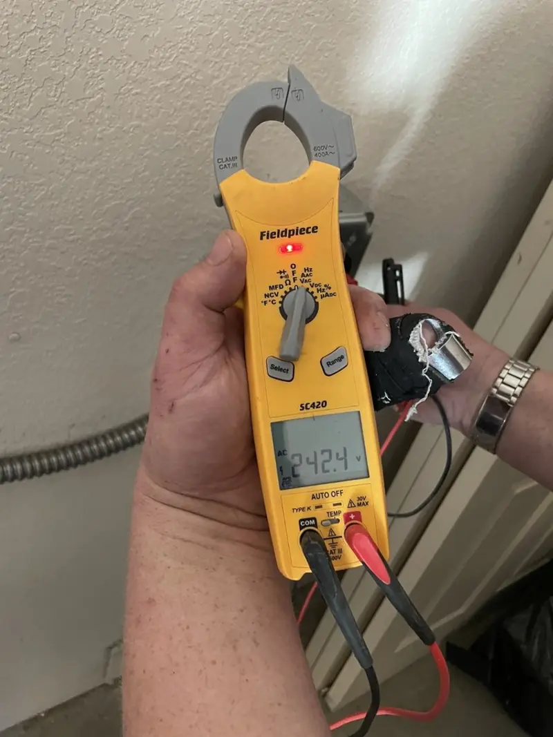Voltage testing with clamp meter during Electrical Installation Services in India Hook